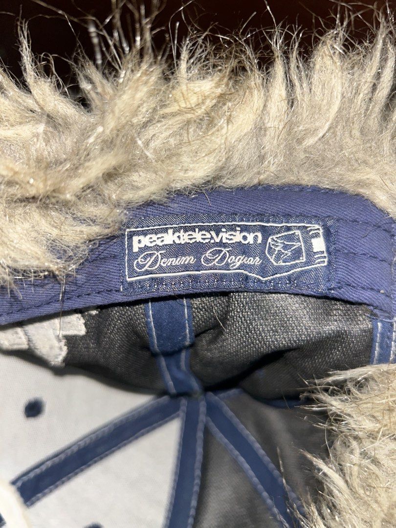 Peak Television Denim Dog Ear Cap (Category: Caps & Hats) located in Manila. Submitted by bella_69 (Listing ID 1445742729, Image 3). Description: - Stylish denim cap with cozy fur ear flaps. - Unique 'Peak TV' embroidery on front and back. - 'Citydweller' embroidery on the side. - Crafted from 100% polyester for durability. - Perfect for making a statement with your look. .