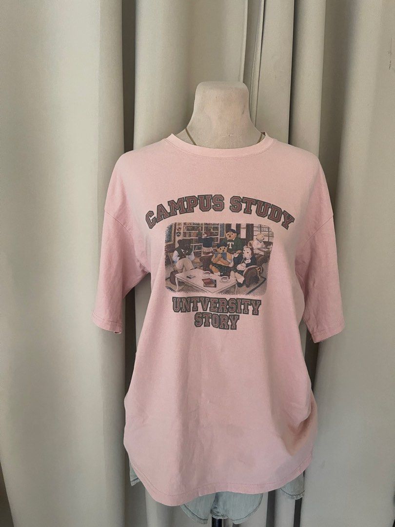 Pink "Campus University Story" (Category: Shirts) located in Cainta. Submitted by zlove111 (Listing ID 1445792875, Image 1). Description: - Adorable pink t-shirt - Features a vintage-style graphic: 'Campus Study University Story' with bears studying in a library - Relaxed fit for comfort - Short sleeves - Ideal for casual outfits and lovers of university aesthetics up to xl cotton last price .
