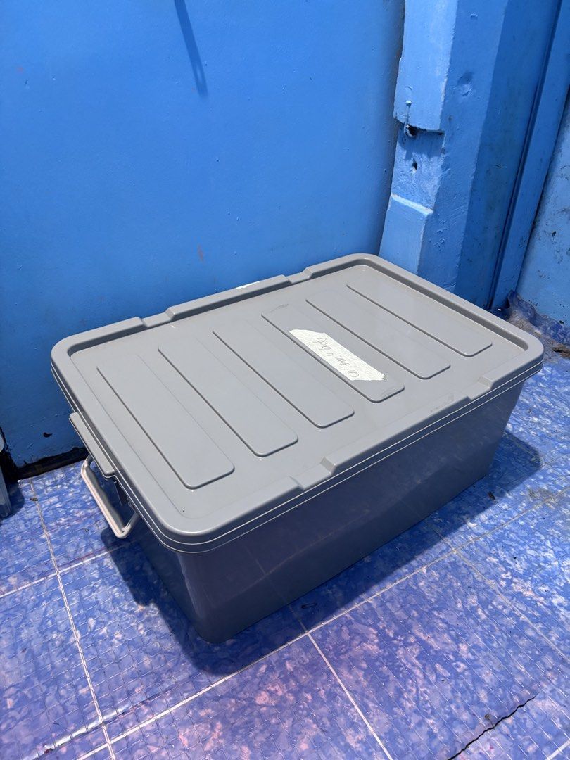 Plain Grey Plastic Storage Box with Lock and Lid (Category: Storage Boxes & Baskets) located in Quezon City. Submitted by jaedenry0228 (Listing ID 1445690038, Image 3). Description: - Grey storage box with secure lid and clips. - Features 'Children's Desk' writing on the lid. - Ideal for organizing toys and other items. - Made of sturdy plastic construction. - Approximate dimensions: [insert dimensions here if known]..