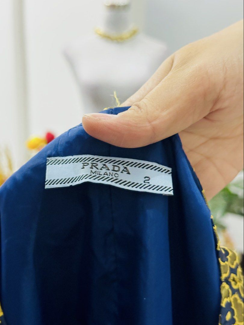 Prada Milano A-Line Dress (Category: Dresses) located in Bugallon. Submitted by itskierbrielle (Listing ID 1445720418, Image 3). Description: - Size Small-Medium - Prada Milano sleeveless A-line dress - Yellow and navy floral jacquard pattern - Zipper closure down the front - Fully lined in navy blue - Perfect for a statement look AUTHENTICATION NOT GUARANTEED. Mine at your own risk ⚠️🌸 .