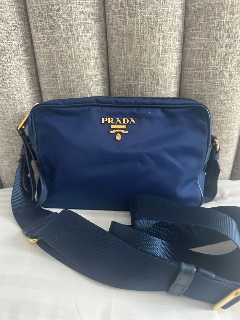 Prada Nylon Camera Crossbody Bag (Category: Luxury Bags & Wallets) located in Quezon City. Submitted by yojxyoj (Listing ID 1445625991, Image 1). Description: - Navy blue Prada crossbody bag - Made from durable nylon with elegant leather trim - Accented with stylish gold hardware - Adjustable strap for a customized and comfortable fit - Secure zipper closure - Ideal for everyday errands and outings.