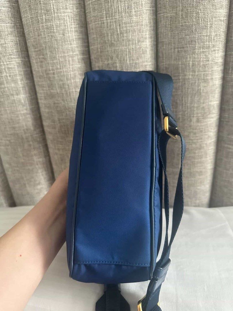Prada Nylon Camera Crossbody Bag (Category: Luxury Bags & Wallets) located in Quezon City. Submitted by yojxyoj (Listing ID 1445625991, Image 3). Description: - Navy blue Prada crossbody bag - Made from durable nylon with elegant leather trim - Accented with stylish gold hardware - Adjustable strap for a customized and comfortable fit - Secure zipper closure - Ideal for everyday errands and outings.