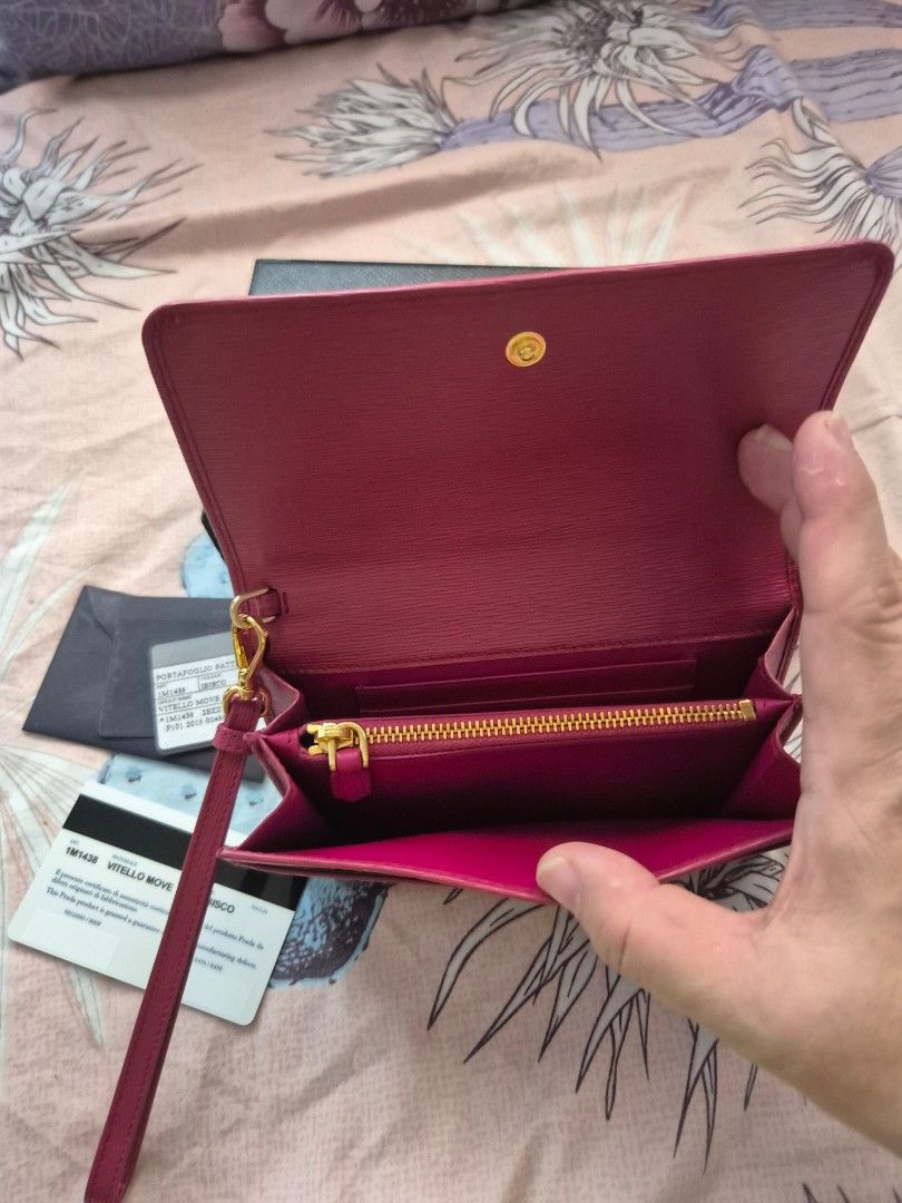 Prada Saffiano Leather Wallet Pink (Category: Luxury Bags & Wallets) located in Quezon City. Submitted by ctatel (Listing ID 1445684561, Image 3). Description: - Authentic Prada wallet - Vibrant pink Saffiano leather - Gold tone hardware - Zipper closure - Detachable wrist strap - Includes original box and authenticity cards - Spacious interior for cards and cash.