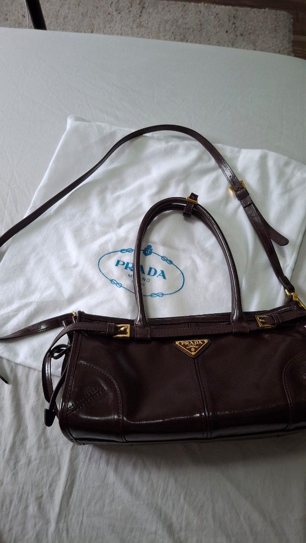 Prada Vitello Shine Crossbody Shoulder Bag (Category: Luxury Bags & Wallets) located in Angono. Submitted by bagamania (Listing ID 1445628455, Image 1). Description: - Prada handbag, crossbody, shoulder bag - NGA - Gold hardware details - Interior zippered pocket - 'Made in Italy' tag - Top handles - Detachable shoulder strap - Includes dust bag - Versatile for everyday or special occasions.