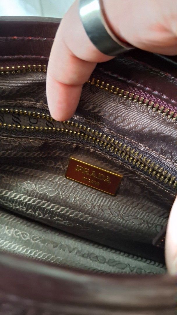 Prada Vitello Shine Crossbody Shoulder Bag (Category: Luxury Bags & Wallets) located in Angono. Submitted by bagamania (Listing ID 1445628455, Image 3). Description: - Prada handbag, crossbody, shoulder bag - NGA - Gold hardware details - Interior zippered pocket - 'Made in Italy' tag - Top handles - Detachable shoulder strap - Includes dust bag - Versatile for everyday or special occasions.