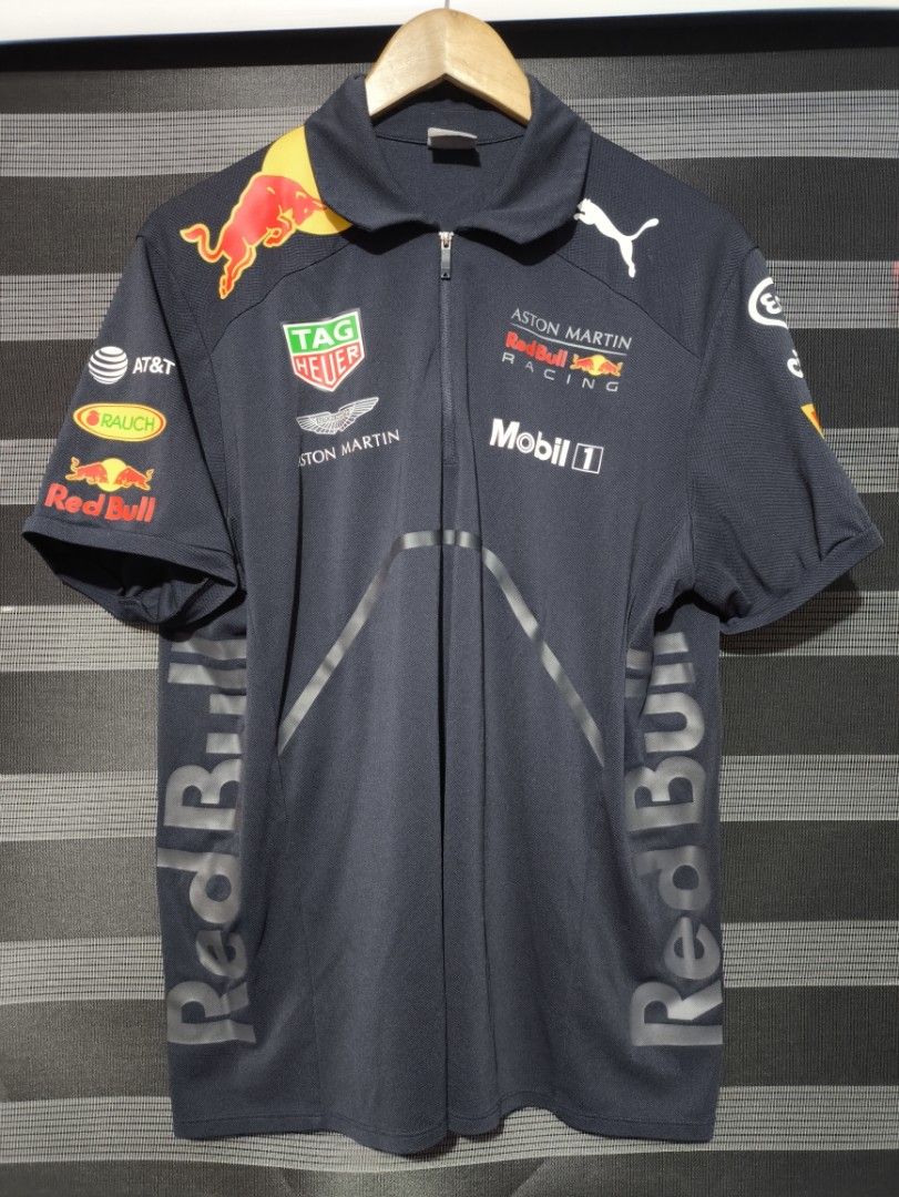 Puma Red Bull (Category: Tshirts & Polo Shirts ) located in Manila. Submitted by joshramly (Listing ID 1445727370, Image 1). Description: - Official Aston Martin Red Bull Racing short sleeve polo shirt - Features Puma branding - Includes sponsor logos: TAG Heuer, Mobil 1 - Zipped collar for a modern look - Ideal for Formula 1 enthusiasts.
