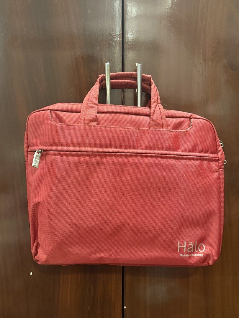 Red Halo Laptop Bag (Category: Laptop Bags & Sleeves) located in Paranaque City. Submitted by fami.liar (Listing ID 1445623026, Image 1). Description: - Red Halo laptop bag - Front zip pocket for quick access - Spacious main compartment - Clean interior lining - Sturdy and comfortable handles - Ideal for carrying laptops and daily essentials - Super matibay, bumagsak na macbook ko while in this bag and walang damage. - looks new RFS: I have a new
