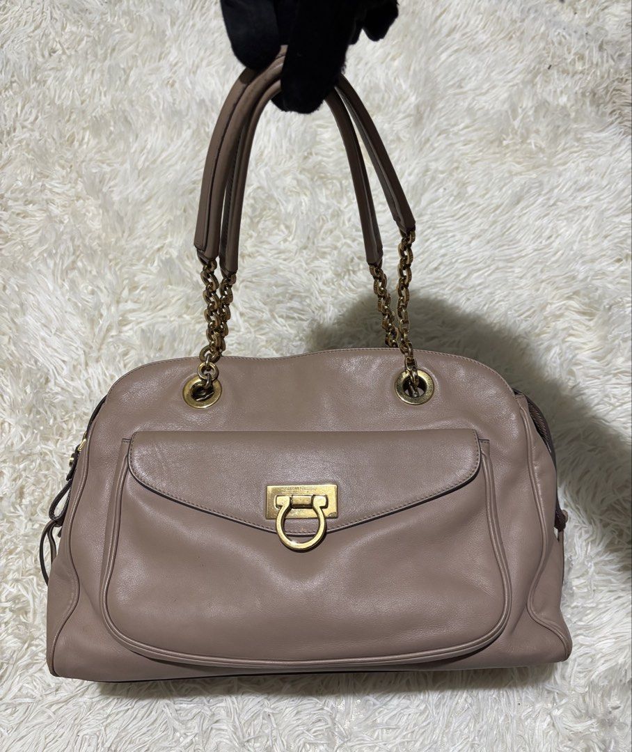 Salvatorre Feragammo (Category: Luxury Bags & Wallets) located in Legazpi City. Submitted by thesource052 (Listing ID 1445787492, Image 2). Description: Salvatorre Ferragamo gancini totebag Beige Gold Hardware. Leather Made in italy Width: 15” Inches Length: 9” Inches Sign Of Usage only Slight Scratch On the edge excellent condition No major flaws Authentic.
