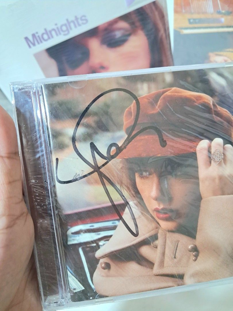 SIGNED Taylor Swift TV Red CD Sealed (Category: CDs & DVDs) located in Taguig. Submitted by call.me.eni (Listing ID 1445669783, Image 2). Description: - Signed Taylor Swift Red CD Sealed - Signature on front cover - Includes Taylor Swift Midnights CD (in background) - Perfect for any Swiftie fan - Comes from a smoke-free home - Rare collectible item Slightly Negotiable.