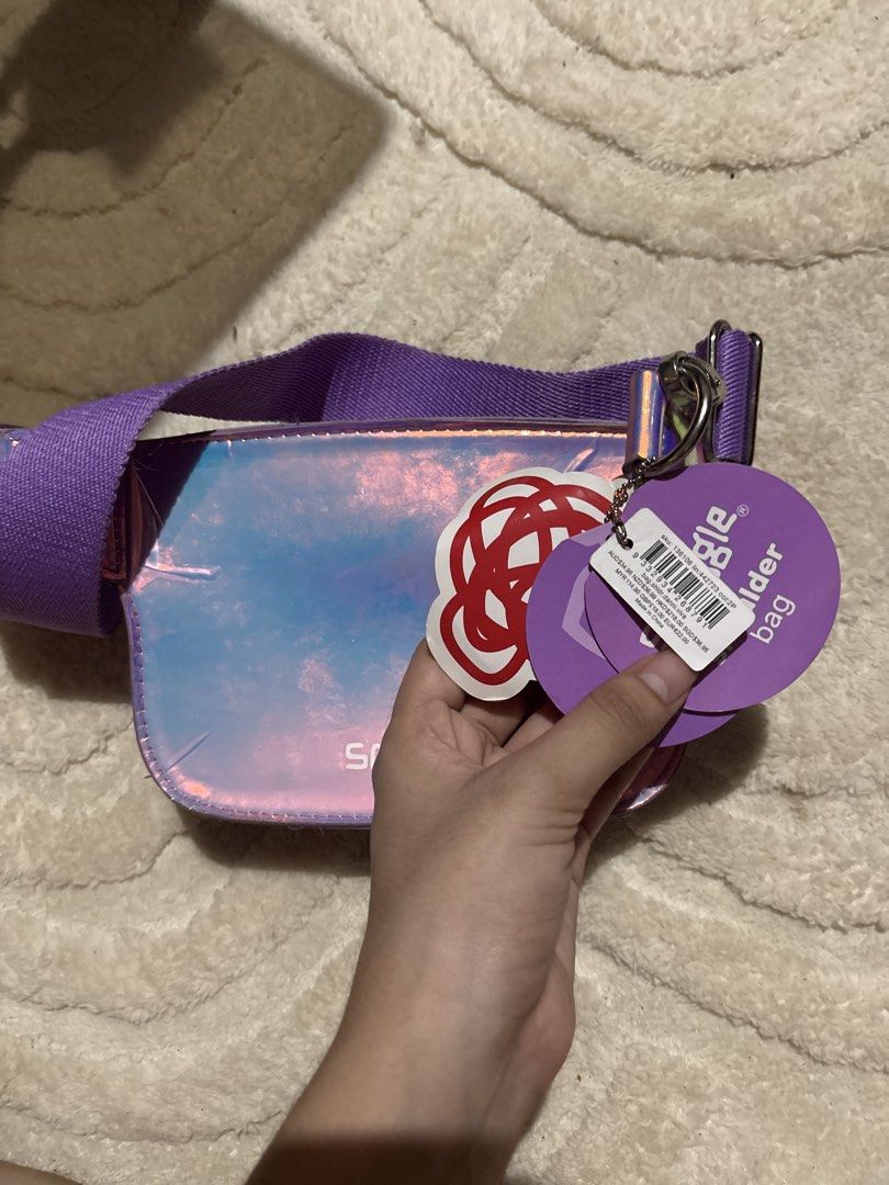 Smiggle Purple Mermaid Shell Shoulder Bag (Category: Shoulder Bags) located in Cabatuan. Submitted by desrceio (Listing ID 1445627389, Image 2). Description: Cute purple Smiggle shoulder bag with mermaid shell design and iridescent finish. Adjustable strap. Brand new with tags. Perfect for kids or fun accessory lovers!.
