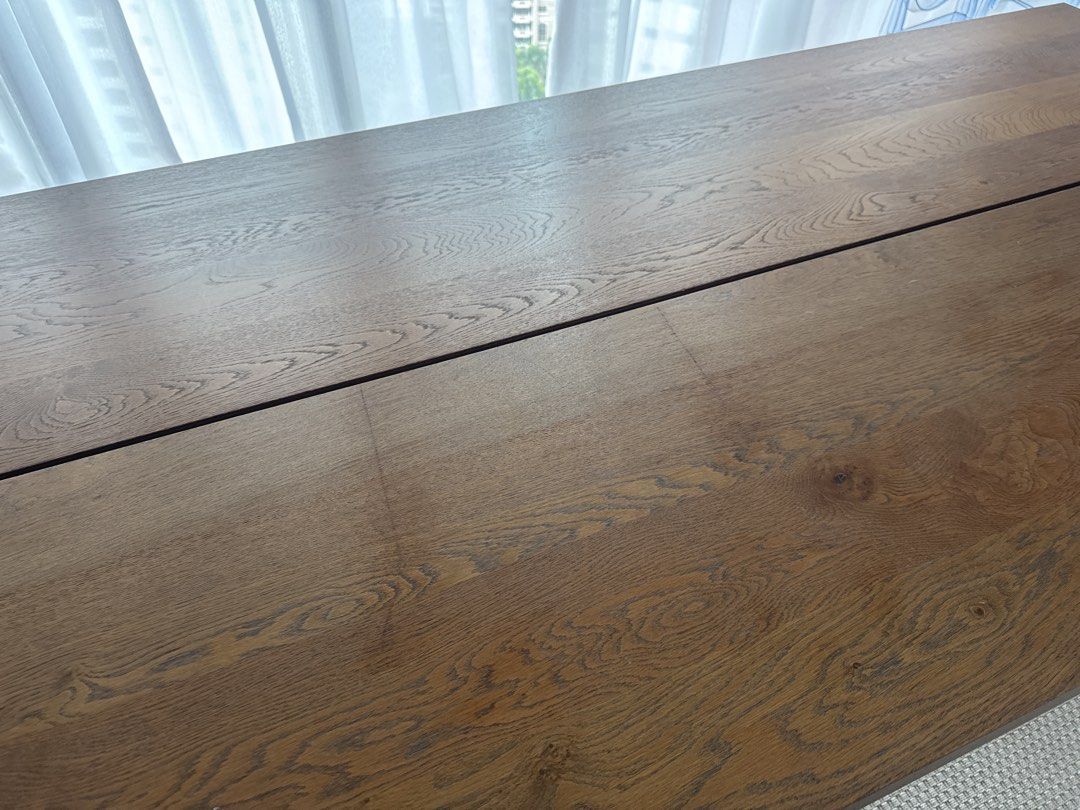 Solid Wood Dining Table (Category: Tables & Sets) located in Singapore. Submitted by traceyannm98935 (Listing ID 1445695508, Image 3). Description: - Solid wood dining table - Natural wood grain finish - Seats 6-8 people comfortably - Table splits into two sections for easier transport - Ideal for family meals and entertaining guests There are some scratches as pictured. Length 220cm Width 100cm Height 75cm.