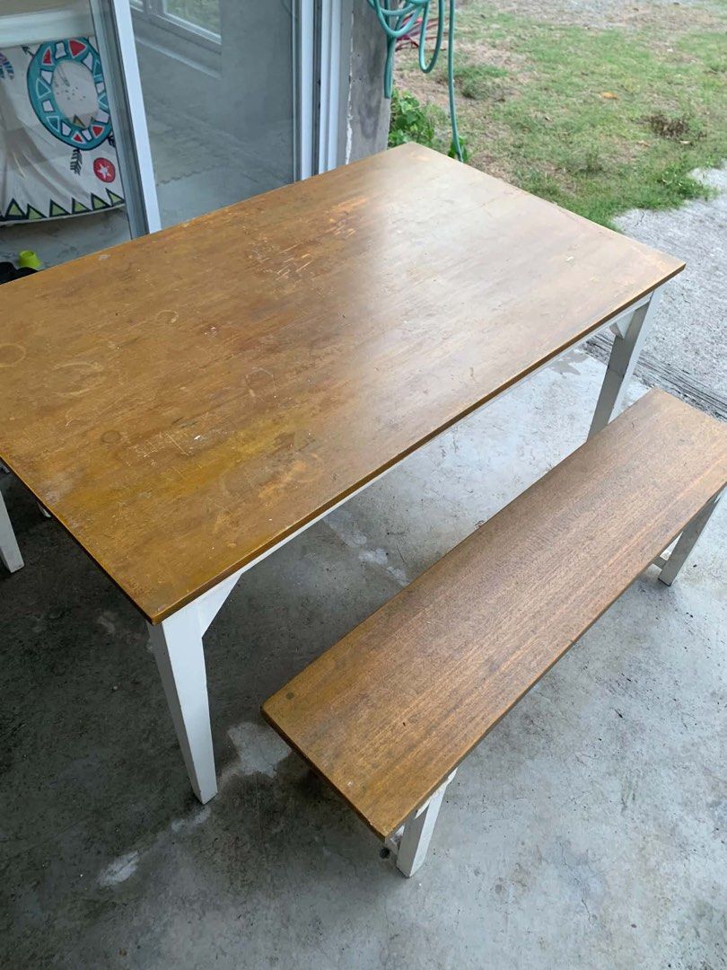 Solid Wooden Dining Table with 2 Benches (Category: Tables & Sets) located in Paombong. Submitted by ronalynr13 (Listing ID 1445647623, Image 3). Description: - Wooden dining table with two matching benches - Light wood tabletop with white legs - Benches also feature wood tops and white legs - Ideal for small spaces or casual dining areas - Suitable for patio or indoor use - Note: Tabletop shows some signs of wear.