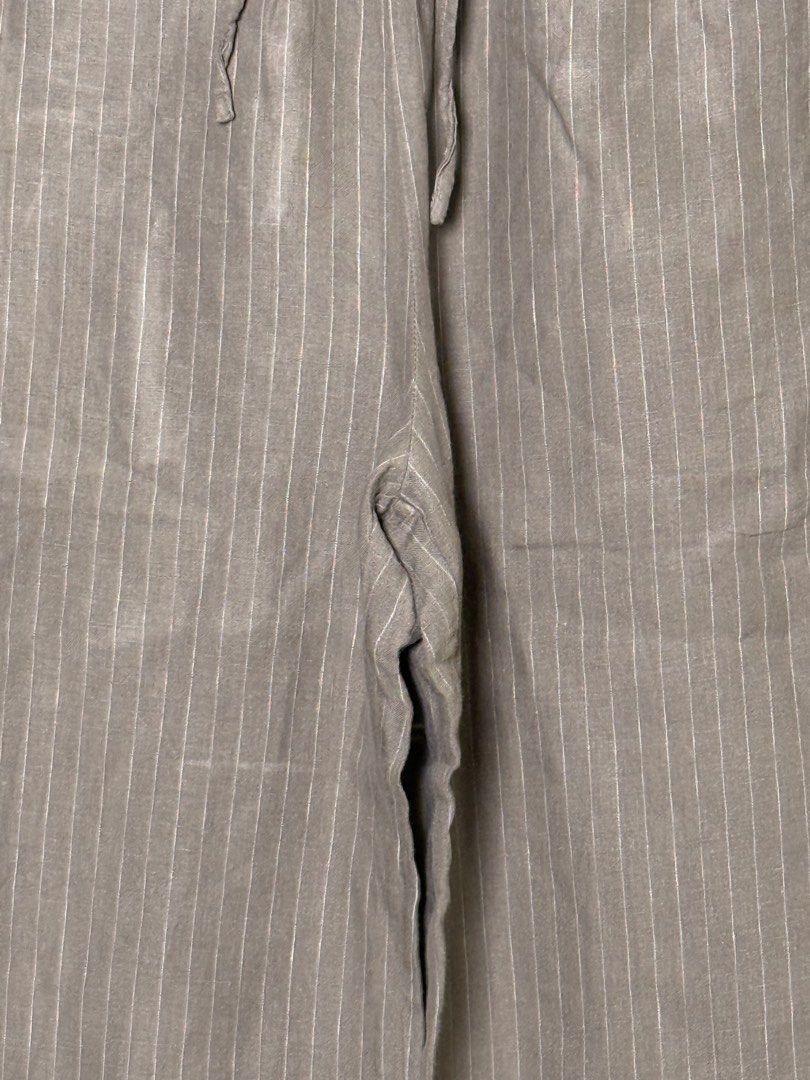 Muji Striped Wide Leg Pants with Drawstring Waist (Category: Other Bottoms) located in Manila. Submitted by iloveyouna_ (Listing ID 1445741000, Image 3). Description: - Grey striped wide leg pants - Comfortable drawstring waist - Lightweight fabric (likely linen blend) - Wide legs with stylish split hem - Versatile for casual wear or lounging - Easy to dress up or down Waist: 30” Length: 35”.
