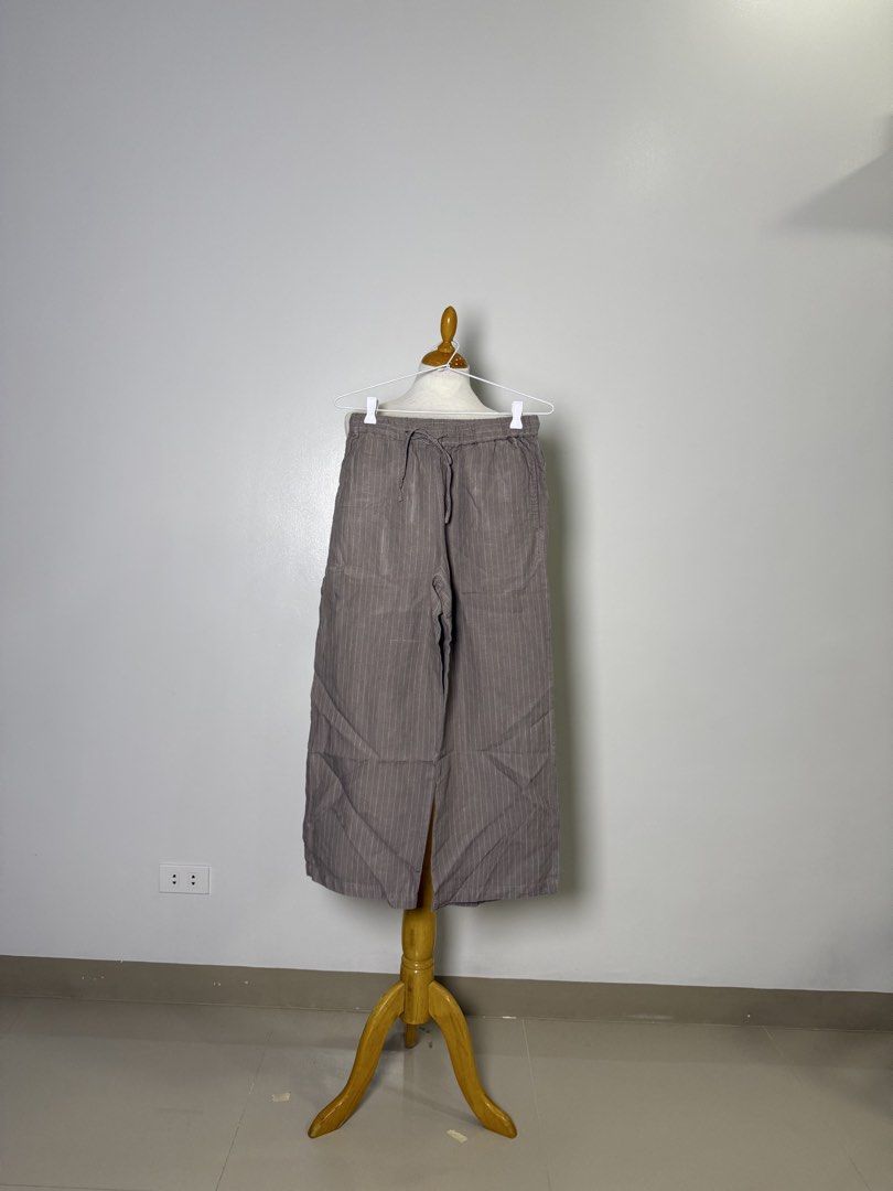 Muji Striped Wide Leg Pants with Drawstring Waist (Category: Other Bottoms) located in Manila. Submitted by iloveyouna_ (Listing ID 1445741000, Image 1). Description: - Grey striped wide leg pants - Comfortable drawstring waist - Lightweight fabric (likely linen blend) - Wide legs with stylish split hem - Versatile for casual wear or lounging - Easy to dress up or down Waist: 30” Length: 35”.