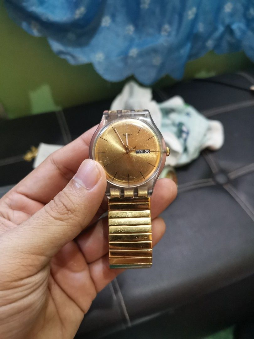 Swatch Watch Gold Tone Day Date (Category: Luxury Watches) located in Manila. Submitted by cleverstone-83765c (Listing ID 1445716468, Image 1). Description: - Gold tone Swatch watch - Features day and date function - Expandable metal strap for a comfortable fit - Classic transparent case design - In excellent working condition - Perfect for everyday wear.