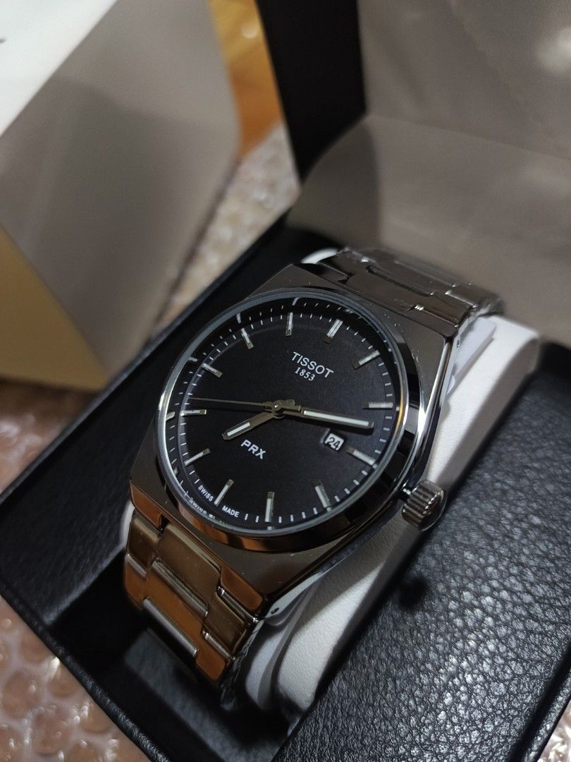 Tissot 1:1 (Category: Luxury Watches) located in Caloocan City. Submitted by seiji09723 (Listing ID 1445761529, Image 1). Description: - Tissot PRX Watch - Classic Black Dial - Durable Stainless Steel Bracelet - Convenient Date Window at 3 o'clock - Comes with Original Box - Versatile for Everyday or Special Occasions.