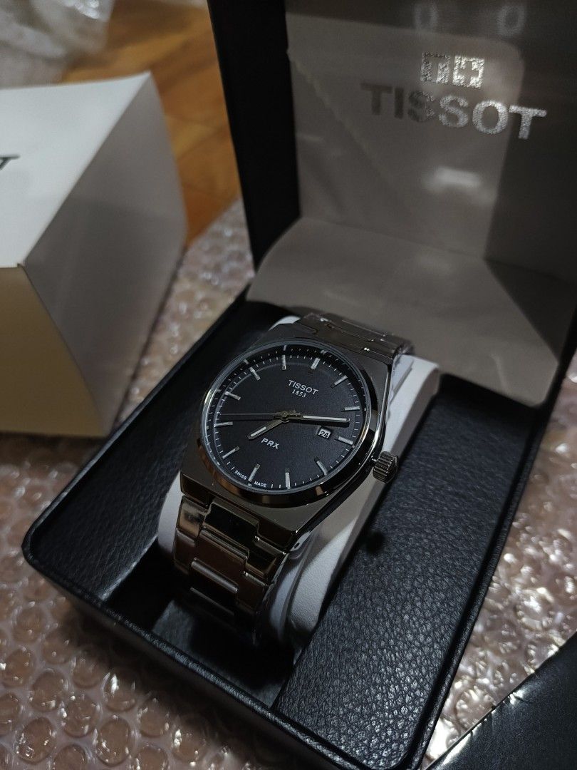 Tissot 1:1 (Category: Luxury Watches) located in Caloocan City. Submitted by seiji09723 (Listing ID 1445761529, Image 2). Description: - Tissot PRX Watch - Classic Black Dial - Durable Stainless Steel Bracelet - Convenient Date Window at 3 o'clock - Comes with Original Box - Versatile for Everyday or Special Occasions.