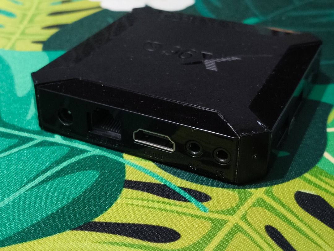 X96Q Android Smart TV 4K Media Player Box (Category: TV) located in Taguig. Submitted by kcdthriftshoppe (Listing ID 1445716441, Image 2). Description: Turn any ordinary TV into a fully functional Smart TV! This compact Android TV box is the ultimate budget setup for streaming your favorite shows, playing retro games, or casting your phone screen directly to the big screen. Condition: Well-used and fully functional. It comes pre-packed with essen
