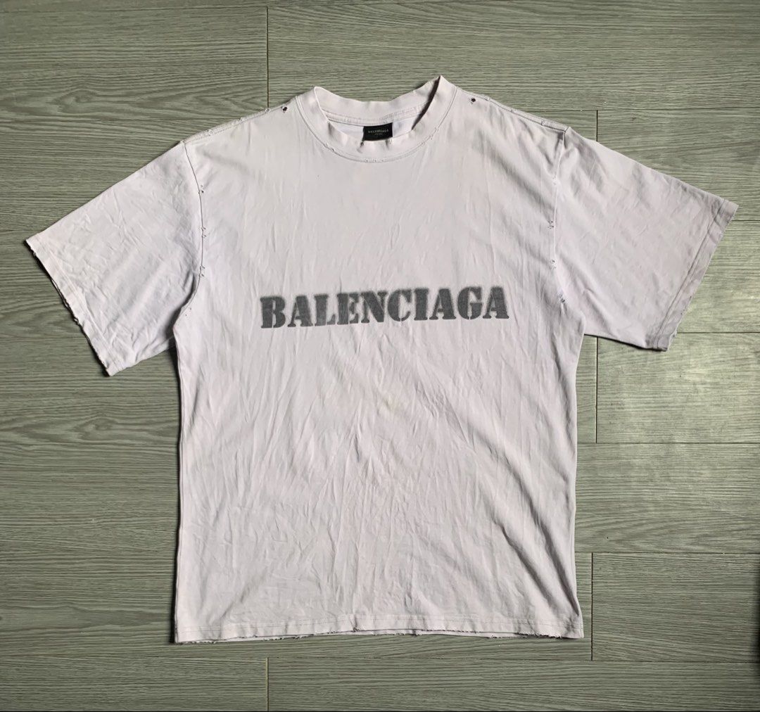 Balenciaga Stencil Type T-Shirt (Category: Luxury Apparel) located in Pozorrubio. Submitted by plco. (Listing ID 1444429495, Image 1). Description: Balenciaga Stencil Type T-Shirt in white vintage jersey featuring a distressed, stencil-style logo. S on tag 23x30 color rate: 9.5/10 complete tags excellent condition need wash only no issue.