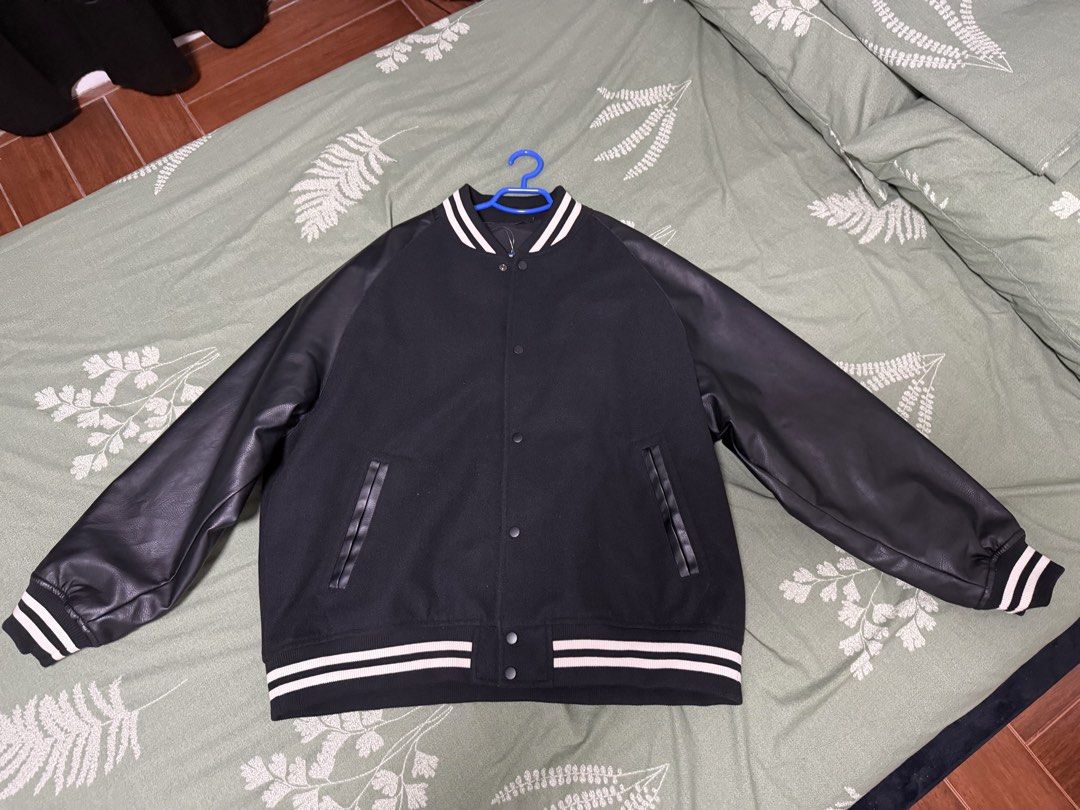 Black Varsity Jacket with Faux Leather Sleeves (Category: Coats, Jackets and Outerwear) located in Quezon City. Submitted by rrsb30 (Listing ID 1445835781, Image 2). Description: - Classic black varsity jacket - Faux leather sleeves - Ribbed cuffs and hem - Snap button front closure - Two side pockets - Ideal for layering - Pairs well with jeans or joggers.