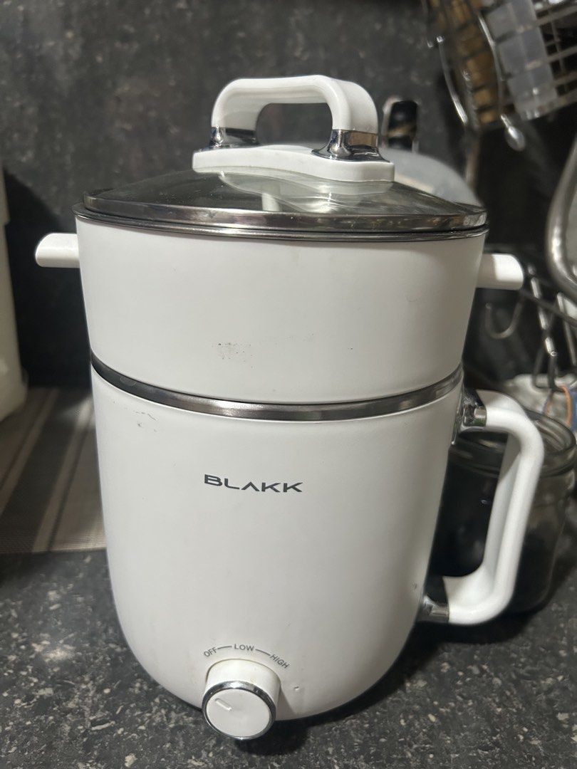 BLAKK Electric Pot with Steamer (Category: Cookware & Accessories) located in Taguig. Submitted by khrystynelp (Listing ID 1445857701, Image 1). Description: - White BLAKK electric pot - Includes glass lid with handle - Comes with a steamer insert - Adjustable heat settings: Off, Low, High - Features white side handles - Ideal for cooking small meals or steaming food.