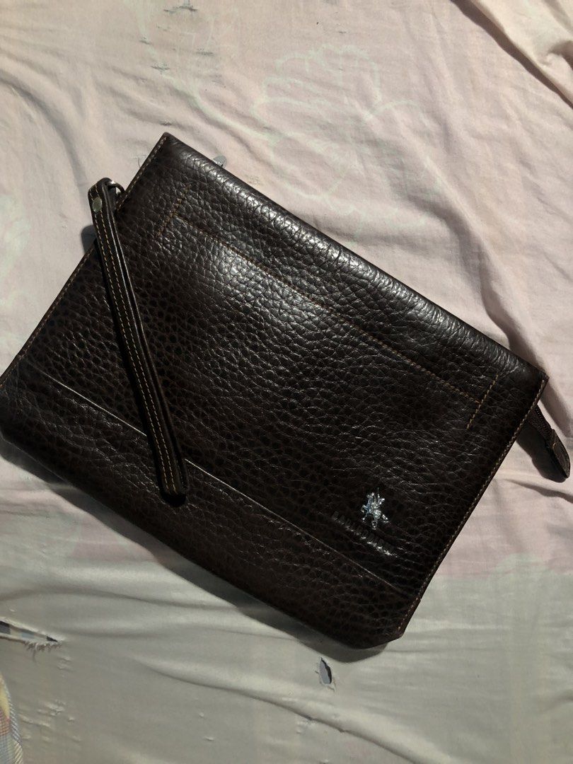 Brown Leather Clutch Bag with Wrist Strap (Category: Belt bags, Clutches and Pouches) located in Munoz. Submitted by bb_jimbo0 (Listing ID 1445942305, Image 1). Description: - Dark brown textured leather clutch - Detachable wrist strap included - Multiple interior compartments for organization - Zippered pocket for secure storage - Dimensions: Approximately 10 inches x 6 inches.