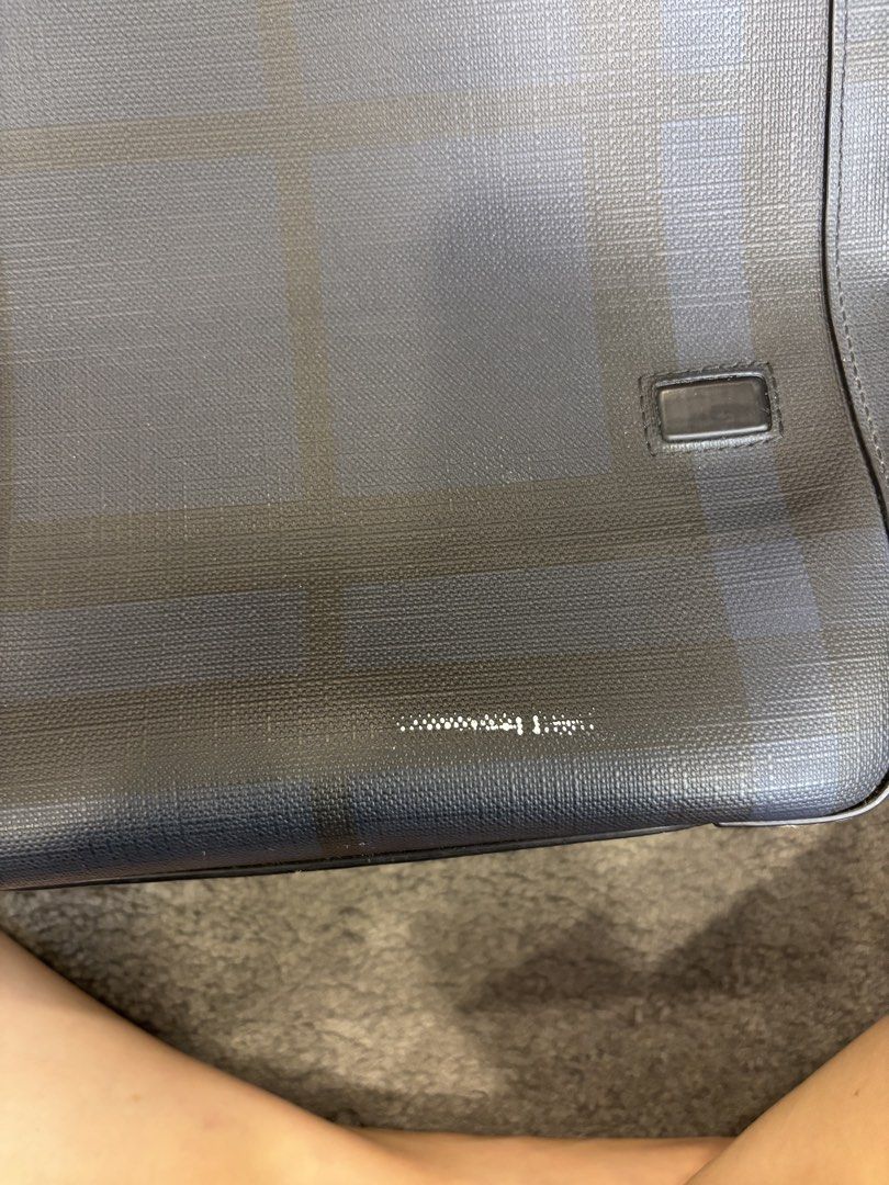 Pre-loved Burberry Nova Check Messenger Bag (Category: Luxury Bags & Wallets) located in Quezon City. Submitted by nikaikochan (Listing ID 1445903550, Image 3). Description: - Authentic Burberry messenger bag - Classic Nova Check pattern (dark grey & blue) - Adjustable strap for comfort - Exterior back zippered pocket - Interior zip pocket with Burberry logo - Minor scuffing on exterior coating (top flap) - Interior is clean.