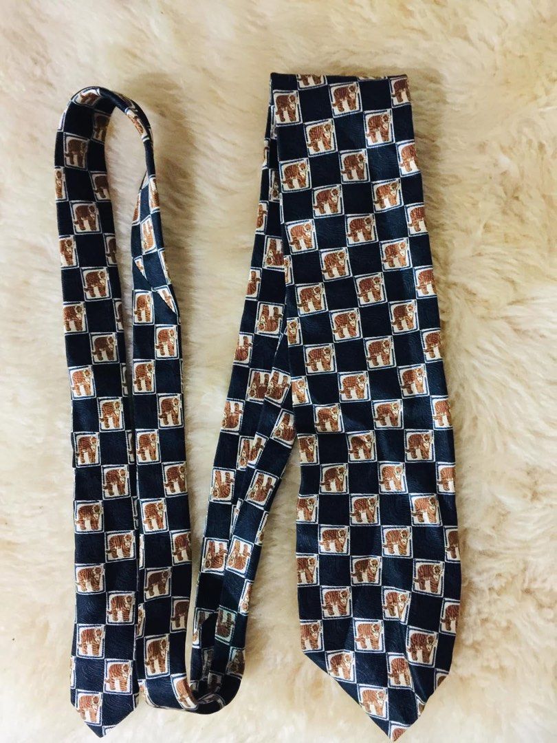 Charleston Tie Made in Italy 100% Silk Tiger Pattern (Category: Ties) located in Baguio. Submitted by izza_thrifty (Listing ID 1445879596, Image 1). Description: - Made in Italy - 100% Silk - Unique checkerboard pattern with tigers - Dark blue base color - Perfect for elevating any outfit.