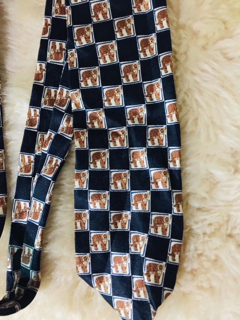 Charleston Tie Made in Italy 100% Silk Tiger Pattern (Category: Ties) located in Baguio. Submitted by izza_thrifty (Listing ID 1445879596, Image 2). Description: - Made in Italy - 100% Silk - Unique checkerboard pattern with tigers - Dark blue base color - Perfect for elevating any outfit.
