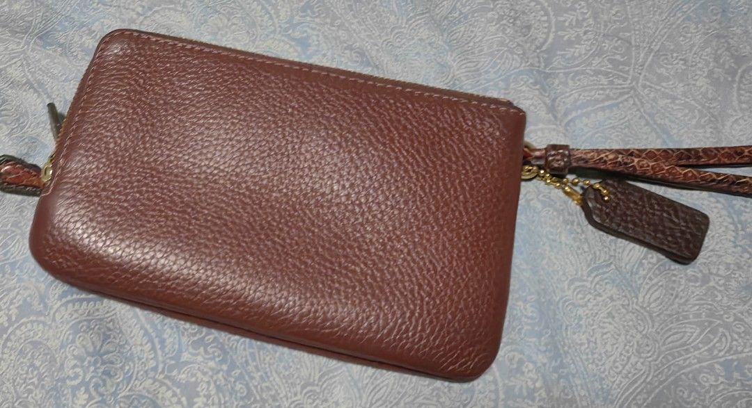 Coach Double Zip Wristlet Burgundy Pebbled Leather (Category: Luxury Bags & Wallets) located in Quezon City. Submitted by flat.earther23 (Listing ID 1445899174, Image 3). Description: - Coach double zip wristlet - Color: Wine - Material: Pebbled leather - Hardware: Gold tone - Includes wrist strap - Comes with Coach hangtag - Ideal for carrying essentials.