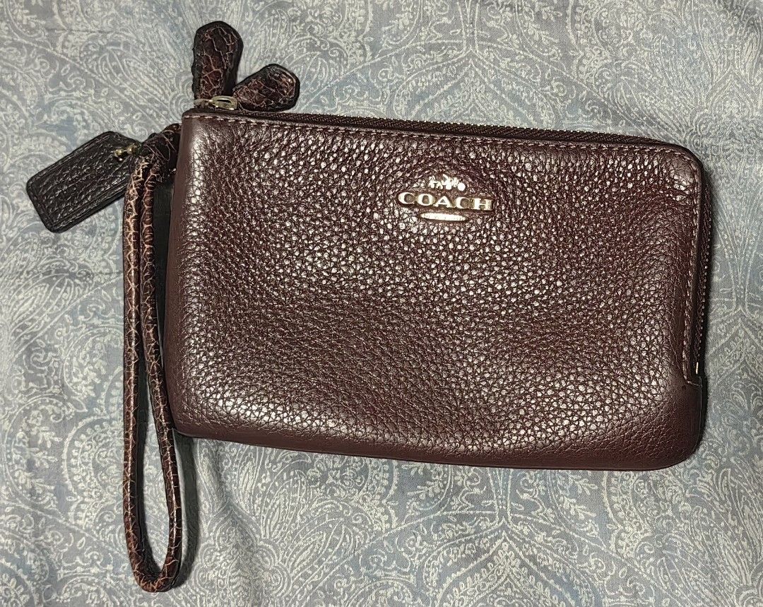 Coach Double Zip Wristlet Burgundy Pebbled Leather (Category: Luxury Bags & Wallets) located in Quezon City. Submitted by flat.earther23 (Listing ID 1445899174, Image 1). Description: - Coach double zip wristlet - Color: Wine - Material: Pebbled leather - Hardware: Gold tone - Includes wrist strap - Comes with Coach hangtag - Ideal for carrying essentials.