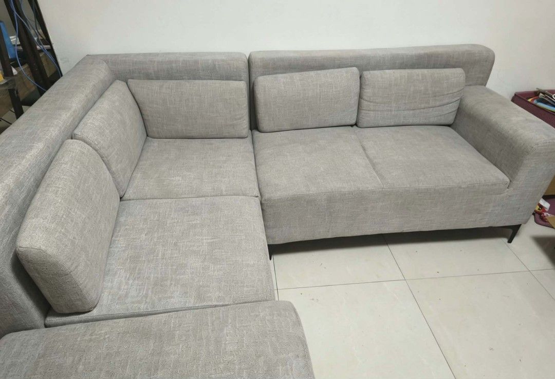 Corner Sofa (Category: Sofas) located in Malolos. Submitted by aemcloset (Listing ID 1445938580, Image 1). Description: - Modern grey fabric corner sofa - Detachable back pillows for customizable comfort - Sleek and contemporary design, perfect for living rooms - Purchased from Abenson Reason for selling: Magmove-out. Hindi kasya sa lilipatang bahay. Issue: may konting stains. kaya pa matanggal pag pinalinis. Price - 15,000 Location Guiguinto Bul