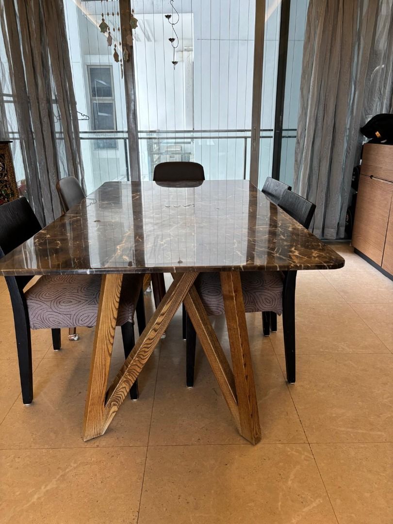 Dining Table (Category: Tables & Sets) located in Singapore. Submitted by meghagoyal79 (Listing ID 1445807737, Image 3). Description: - Dining table with a sophisticated marble-effect tabletop. - Features a stylish and sturdy modern wooden base. - Chairs shown are available and complement the table. - Ideal for creating a chic dining space..