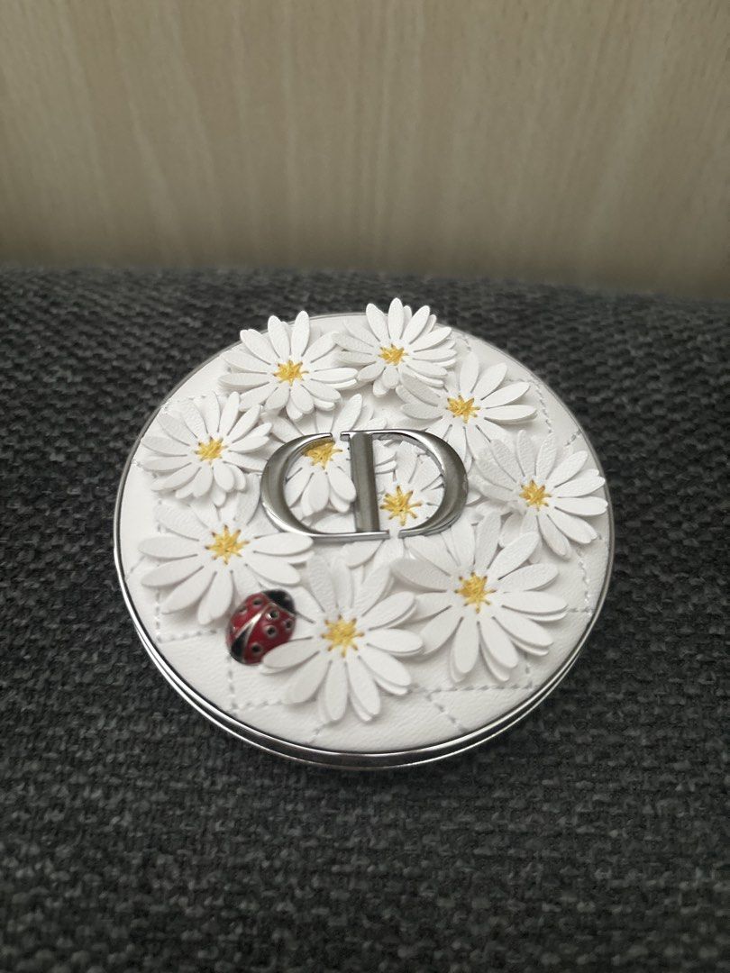 Dior Limited Edition Highlighter Compact - Daisy & Ladybug Design (Category: Makeup) located in Makati City. Submitted by thriftshopmkti (Listing ID 1445848214, Image 1). Description: LAST PRICE POSTED - Limited Edition Dior Highlighter - Features a beautiful quilted white case - Adorned with a charming daisy and ladybug design - Highlighter offers a subtle, natural shimmer - Perfect for achieving a healthy glow - Compact and travel-friendly size