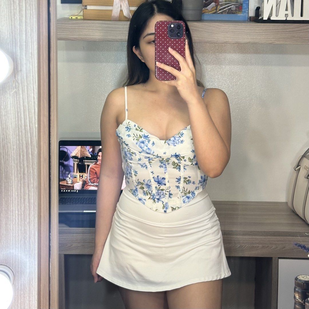 Floral Corset Top with Spaghetti Straps (Category: Sleeveless) located in Cainta. Submitted by yayitsianm (Listing ID 1445969520, Image 3). Description: - Cream corset top with a chic blue floral print. - Sweetheart neckline and adjustable spaghetti straps for a perfect fit. - Structured bodice with boning for a flattering silhouette. - Versatile piece that pairs beautifully with skirts or jeans..