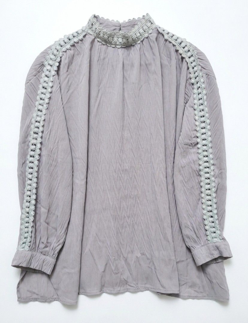 Grey Long Sleeve Blouse with Lace Trim (Category: Blouses) located in Donsol. Submitted by saksthriftavenuebyluckymaria8 (Listing ID 1445795038, Image 2). Description: - Light grey long sleeve blouse - High neckline with gathered detail - Pretty lace trim along shoulders and sleeves - Subtle textured stripe fabric - Can be tucked in or worn loose - Easy to dress up or down This grey chantal blouse features distinctive ivory lace embellishments al