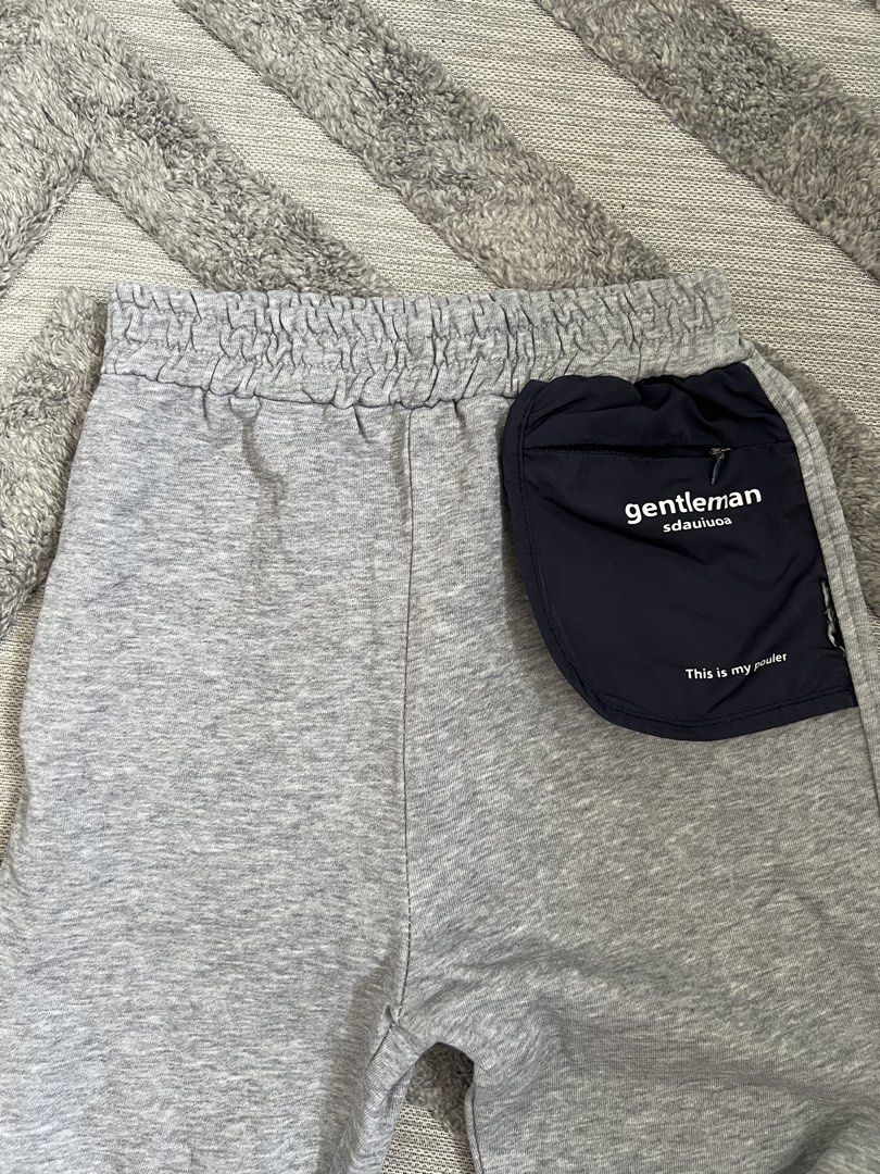 Grey Sweatpants with Navy Pocket Detail (Category: Babies & Kids Fashion) located in Dasmarinas. Submitted by shoptinyframe (Listing ID 1445804501, Image 2). Description: - Comfy grey sweatpants - Elastic waistband for a comfortable fit - Navy blue pocket on the right side - Ideal for lounging and casual wear - Versatile: easily pairs with any top.