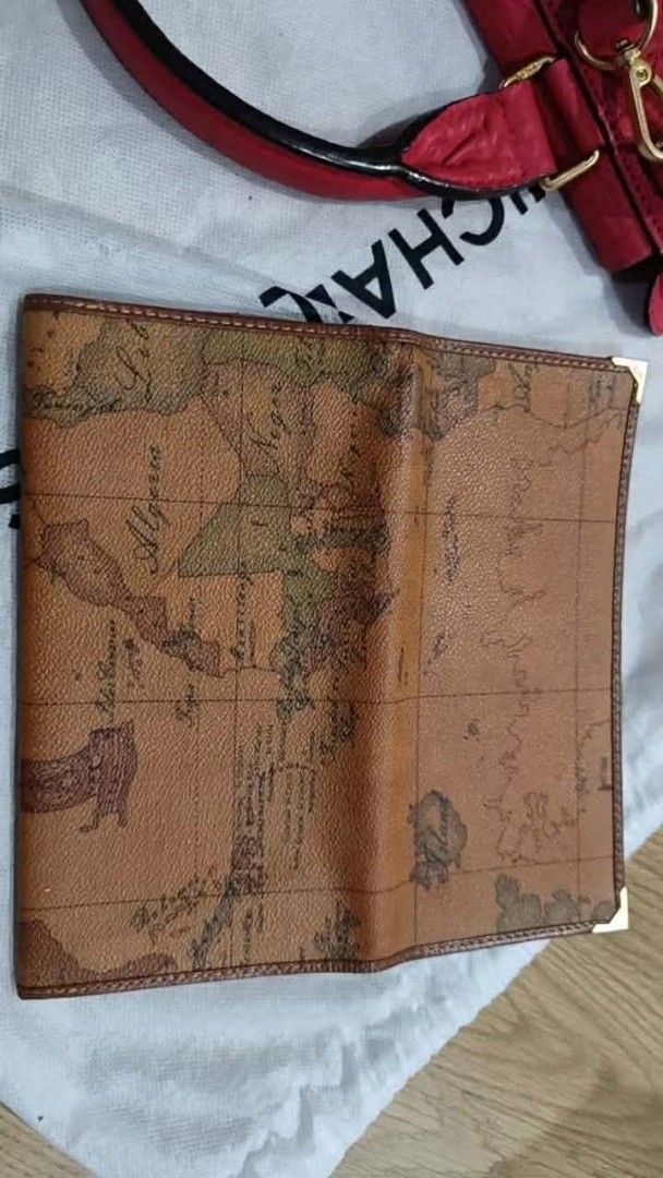 Authentic Alviero Martini 1a Classe Map Print Bi-fold Wallet (Category: Luxury Bags & Wallets) located in Binan City. Submitted by just.call.me_lazy (Listing ID 1445974084, Image 2). Description: Authentic Alviero Martini 1ª Classe Bi-fold Wallet ✨ Iconic vintage map motif, Made in Italy 💼 Elegant design with metallic corner protectors 🪙 Multiple card slots + zippered compartment, practical and stylish ✔️ Embossed brand stamp: Alviero Martini 1