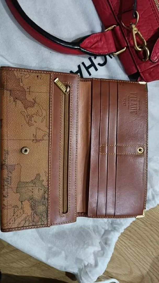 Authentic Alviero Martini 1a Classe Map Print Bi-fold Wallet (Category: Luxury Bags & Wallets) located in Binan City. Submitted by just.call.me_lazy (Listing ID 1445974084, Image 3). Description: Authentic Alviero Martini 1ª Classe Bi-fold Wallet ✨ Iconic vintage map motif, Made in Italy 💼 Elegant design with metallic corner protectors 🪙 Multiple card slots + zippered compartment, practical and stylish ✔️ Embossed brand stamp: Alviero Martini 1