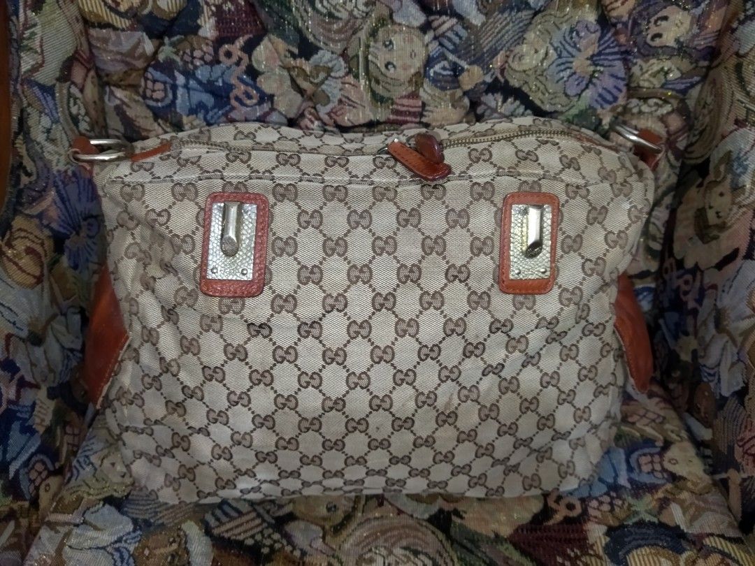 Gucci Monogram Canvas Leather Trim 2 way Bag (Category: Luxury Bags & Wallets) located in Santa Cruz. Submitted by madonnaching (Listing ID 1445820187, Image 2). Description: - Authentic Gucci 2way bag (project bag) - Classic GG monogram canvas - Brown leather trim and handles - Zipper closure - Interior zip pocket - Made in Italy - Great everyday bag no handle and sling.