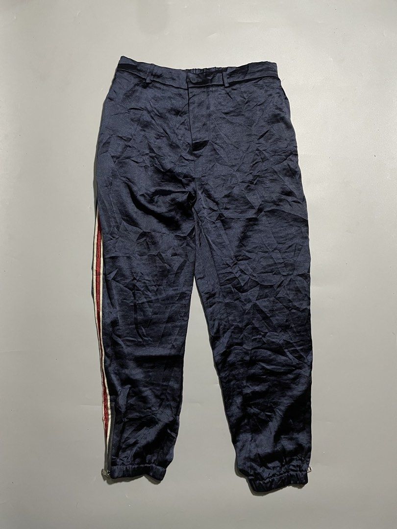 Gucci Ankle Zipped Jogger Pants (Category: Luxury Apparel) located in Taguig. Submitted by sellnbustle (Listing ID 1445890247, Image 2). Description: Gucci Navy Blue Ankle Zipped Jogger Pants Size Large 30 Waist 38.5” Length Excellent condition - Gucci navy blue track pants - Signature red and white stripe down the side - Elastic waistband with drawstring for adjustable fit - Zippers at the ankle for styling options - Made in Italy - Ideal for ca