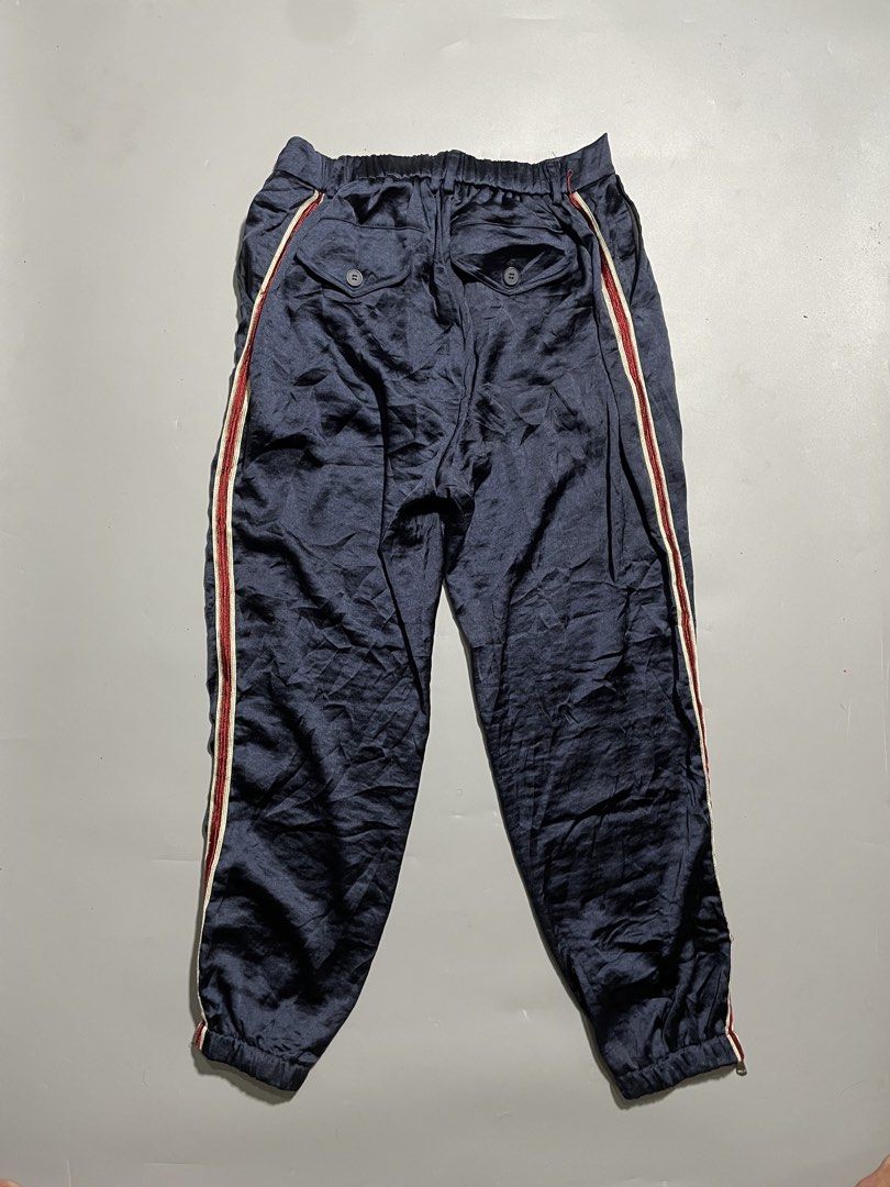 Gucci Ankle Zipped Jogger Pants (Category: Luxury Apparel) located in Taguig. Submitted by sellnbustle (Listing ID 1445890247, Image 3). Description: Gucci Navy Blue Ankle Zipped Jogger Pants Size Large 30 Waist 38.5” Length Excellent condition - Gucci navy blue track pants - Signature red and white stripe down the side - Elastic waistband with drawstring for adjustable fit - Zippers at the ankle for styling options - Made in Italy - Ideal for ca