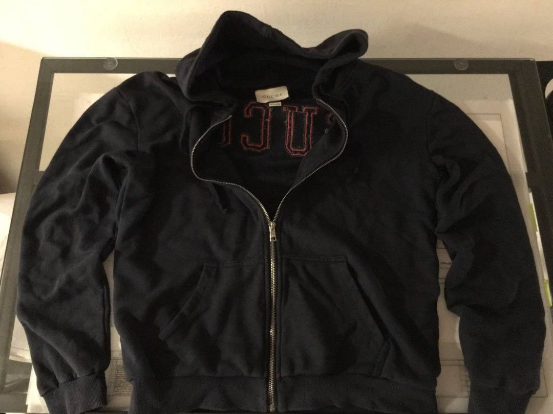 Gucci Navy Blue Zip-Up Hoodie (Category: Coats, Jackets and Outerwear) located in Pasig City. Submitted by devlux (Listing ID 1445926009, Image 3). Description: - Authentic Navy Blue Gucci Hoodie - Iconic Gucci logo on chest and back - Zip-up front with pockets - Made in Italy - Size: L - Approximate Measurements: 23 inches (width) x 26 inches (length).