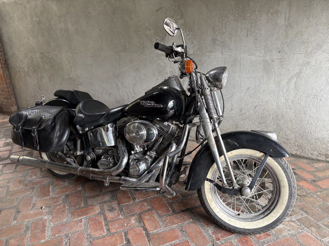 Harley-Davidson Motorcycle with Saddlebags (Category: Motorbikes for Sale) located in Quezon City. Submitted by 33mdmc (Listing ID 1445850812, Image 1). Description: Classic black Harley-Davidson motorcycle. Equipped with leather saddlebags for storage. Whitewall tires add to the vintage look. Chrome accents throughout. Ready for the road. Great for cruising..