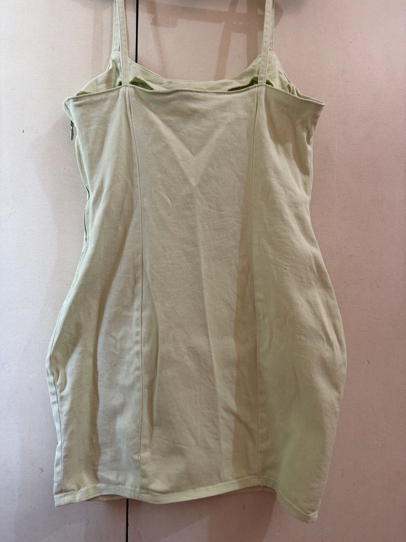 H&M Divided Light Green Denim Mini Dress (Category: Dresses) located in Manila. Submitted by lifeofchamppreloved (Listing ID 1445815330, Image 2). Description: - Light green denim mini dress - Brand: H&M Divided - Features spaghetti straps and a side zipper - Minor marks on fabric (visible in the last photo).