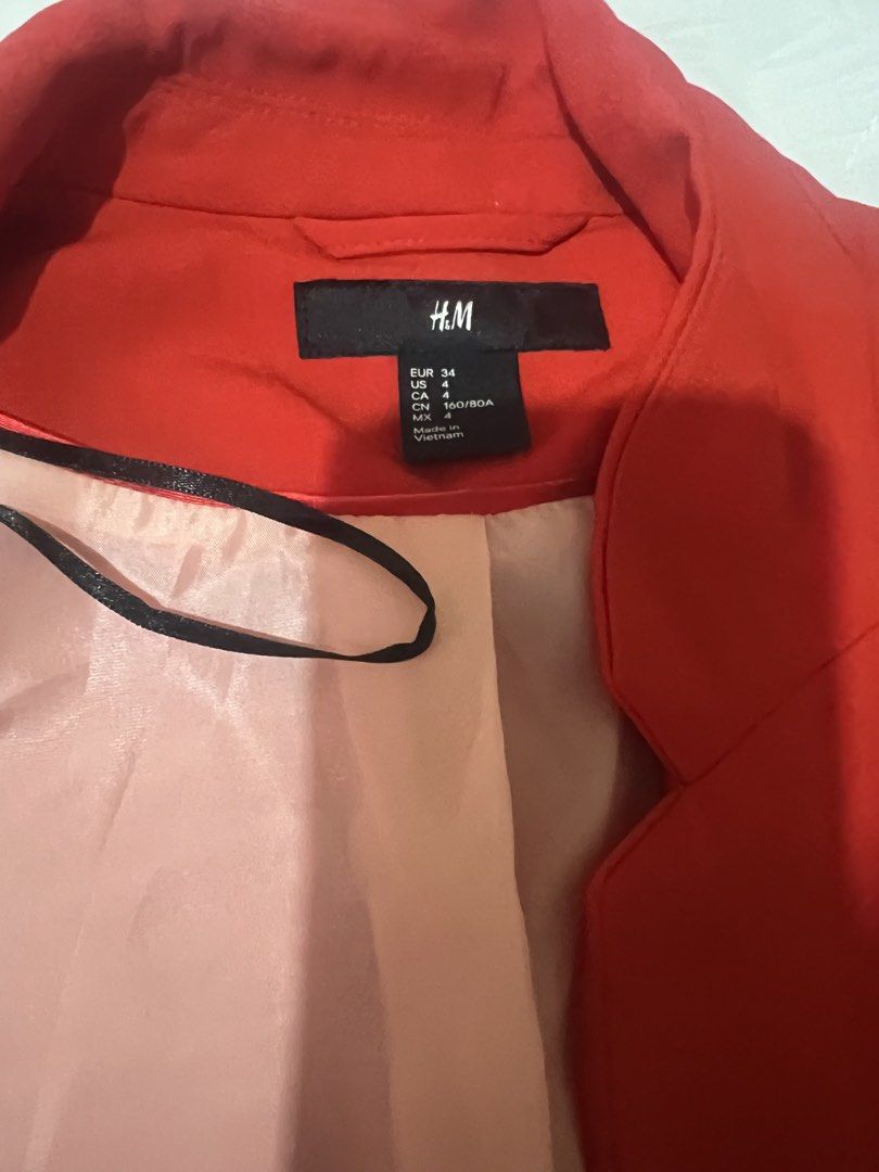 H&M Red Collarless Blazer (Category: Coats, Jackets and Outerwear) located in Marikina City. Submitted by declutteringcarly (Listing ID 1445844933, Image 2). Description: - H&M Red Blazer - super like new and vibrant color -used once only bought brand new - red orangy ang kulay - can fit XS-medium.