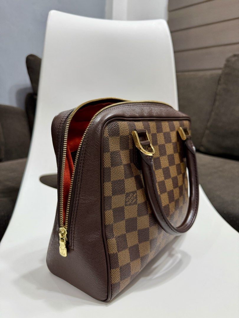 Louis Vuitton Damier Ebene Brera Handbag (Category: Luxury Bags & Wallets) located in Manila. Submitted by thecuratedfind (Listing ID 1445931412, Image 2). Description: - Vintage Louis Vuitton Damier Ebene Brera - Damier Ebene canvas with iconic checkered pattern - Brown leather trim and gold hardware - Vibrant red fabric interior lining - Secure zipper closure - Spacious main compartment - Interior zip pocket for organization - Timeless and vers
