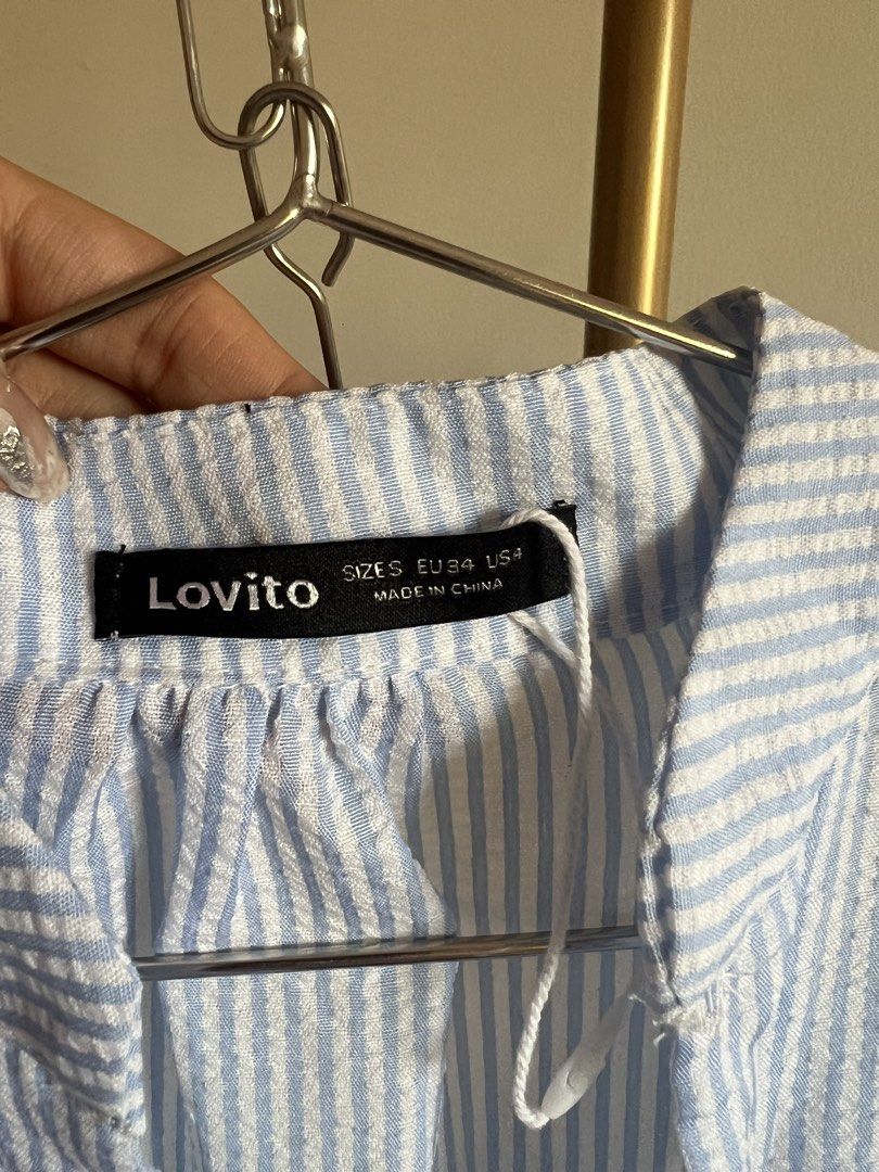 Lovito Blue Striped Tiered Button-Up Dress (Category: Dresses) located in Makati City. Submitted by audreyngoldilocks (Listing ID 1445880484, Image 2). Description: Worn only once for a shoot :) Rfs need closet space Super presko! - Lovito blue and white striped dress - High neckline with short puff sleeves - Button-up front - Tiered, flowy skirt - Seersucker-like fabric - Ideal for casual occasions.