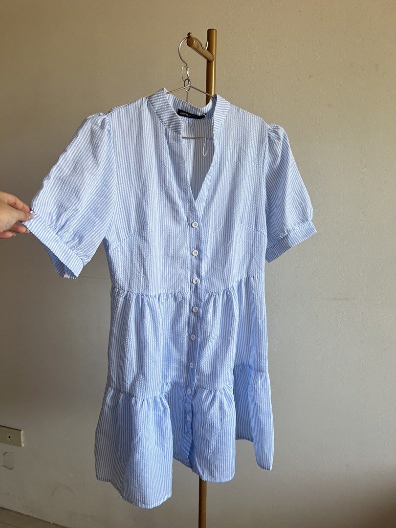 Lovito Blue Striped Tiered Button-Up Dress (Category: Dresses) located in Makati City. Submitted by audreyngoldilocks (Listing ID 1445880484, Image 1). Description: Worn only once for a shoot :) Rfs need closet space Super presko! - Lovito blue and white striped dress - High neckline with short puff sleeves - Button-up front - Tiered, flowy skirt - Seersucker-like fabric - Ideal for casual occasions.