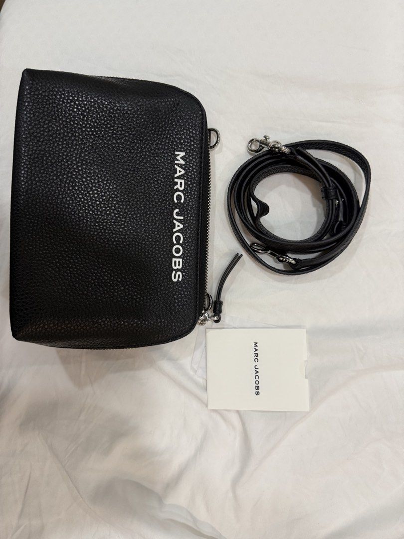 Marc Jacobs Black Leather Crossbody with Strap (Category: Luxury Bags & Wallets) located in Quezon City. Submitted by venezia13 (Listing ID 1445958194, Image 1). Description: - Authentic Marc Jacobs black pebbled leather pouch - Vertical brand name print on the side - Detachable crossbody strap with silver hardware - Comes with a small card - Ideal for carrying your essentials.